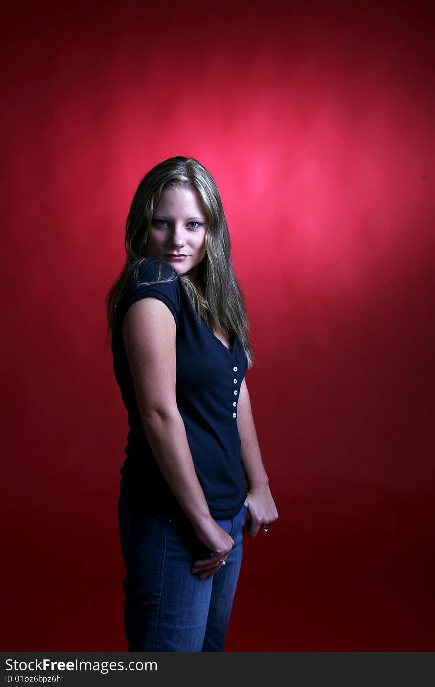 Pretty young woman against a hot red background