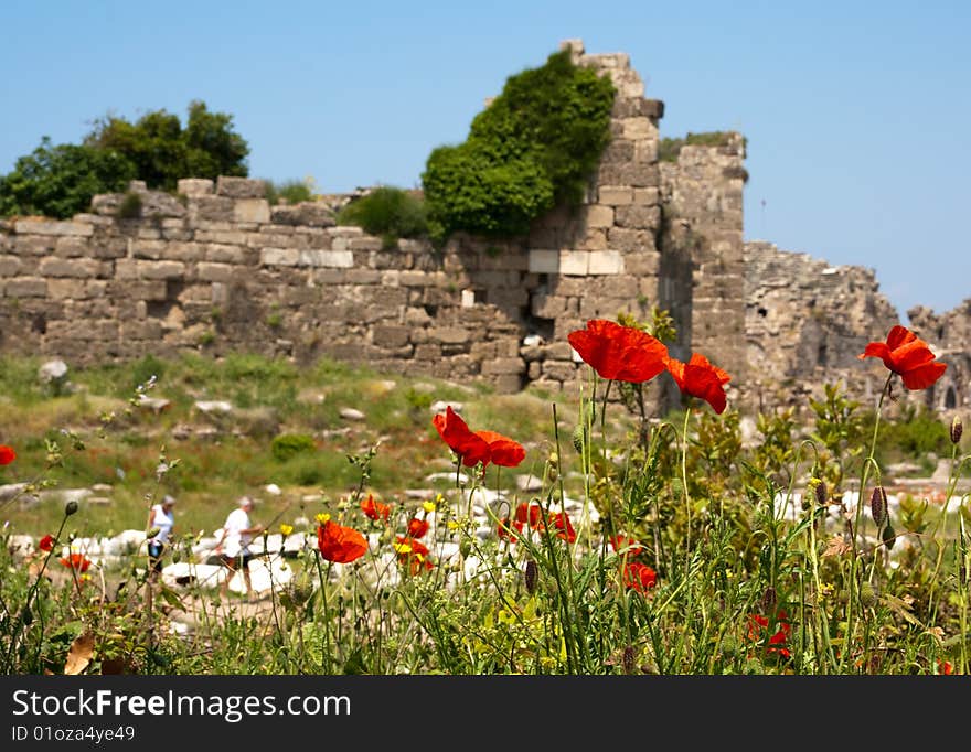 Ruins of old town. red poppies in the foreground