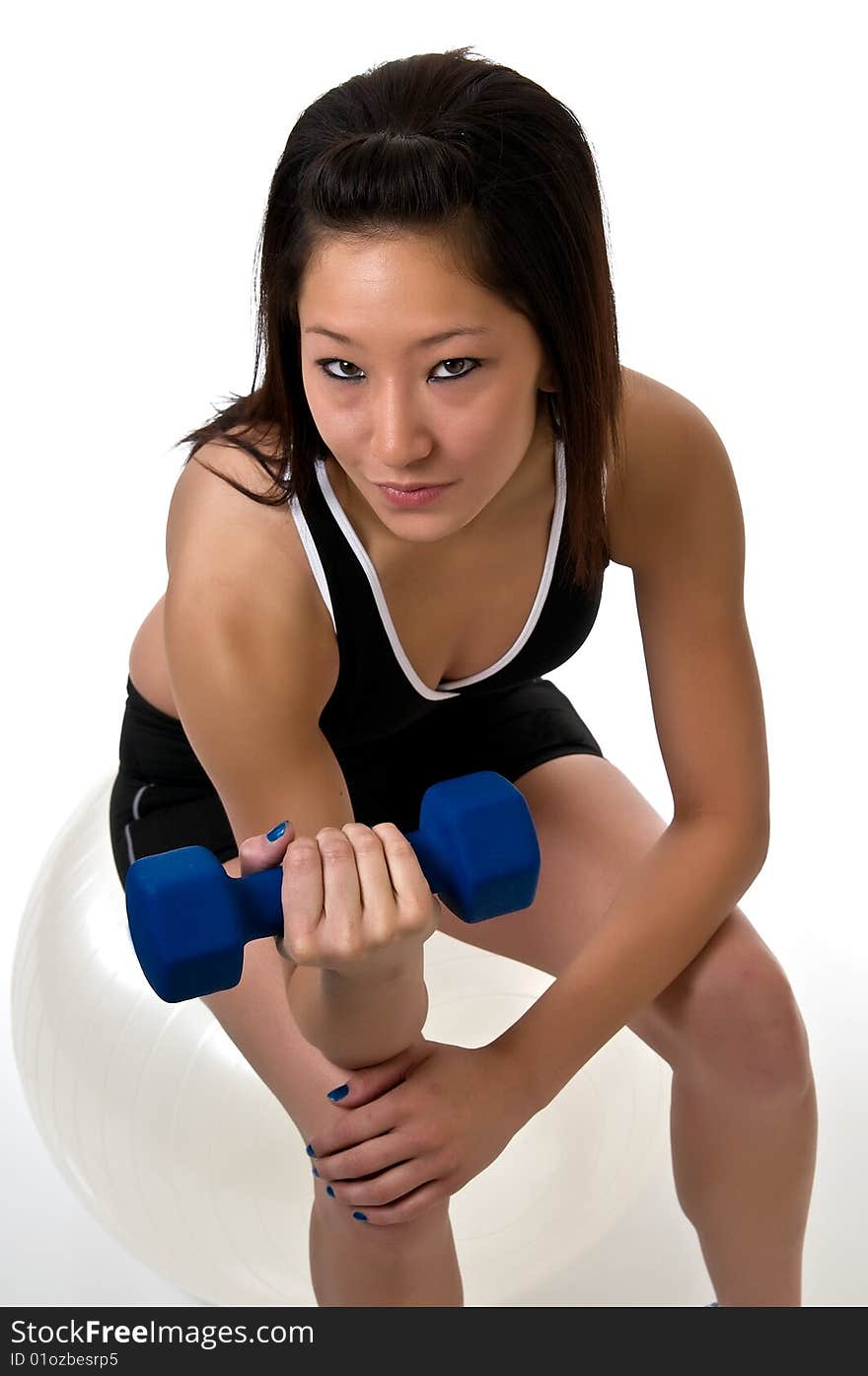 Fit, young, Asian woman exercising with weights. Fit, young, Asian woman exercising with weights.