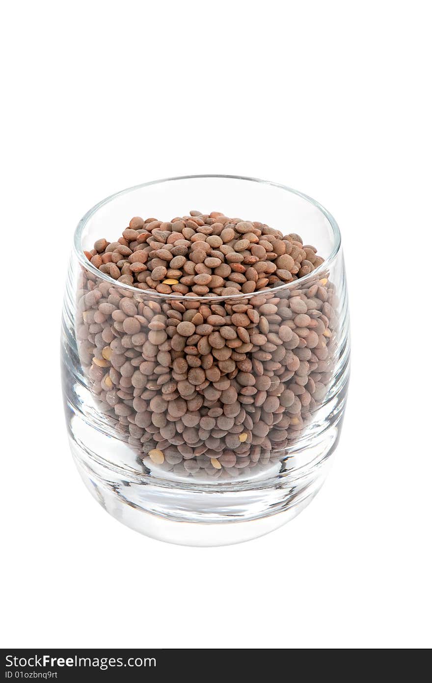 Green lentils in glass, white background