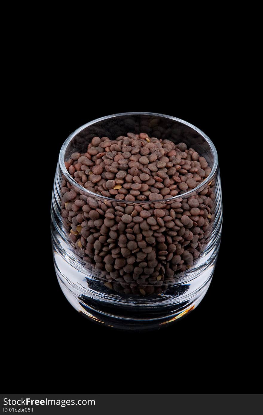 Pardina lentils in glass, isolated on black background. Pardina lentils in glass, isolated on black background