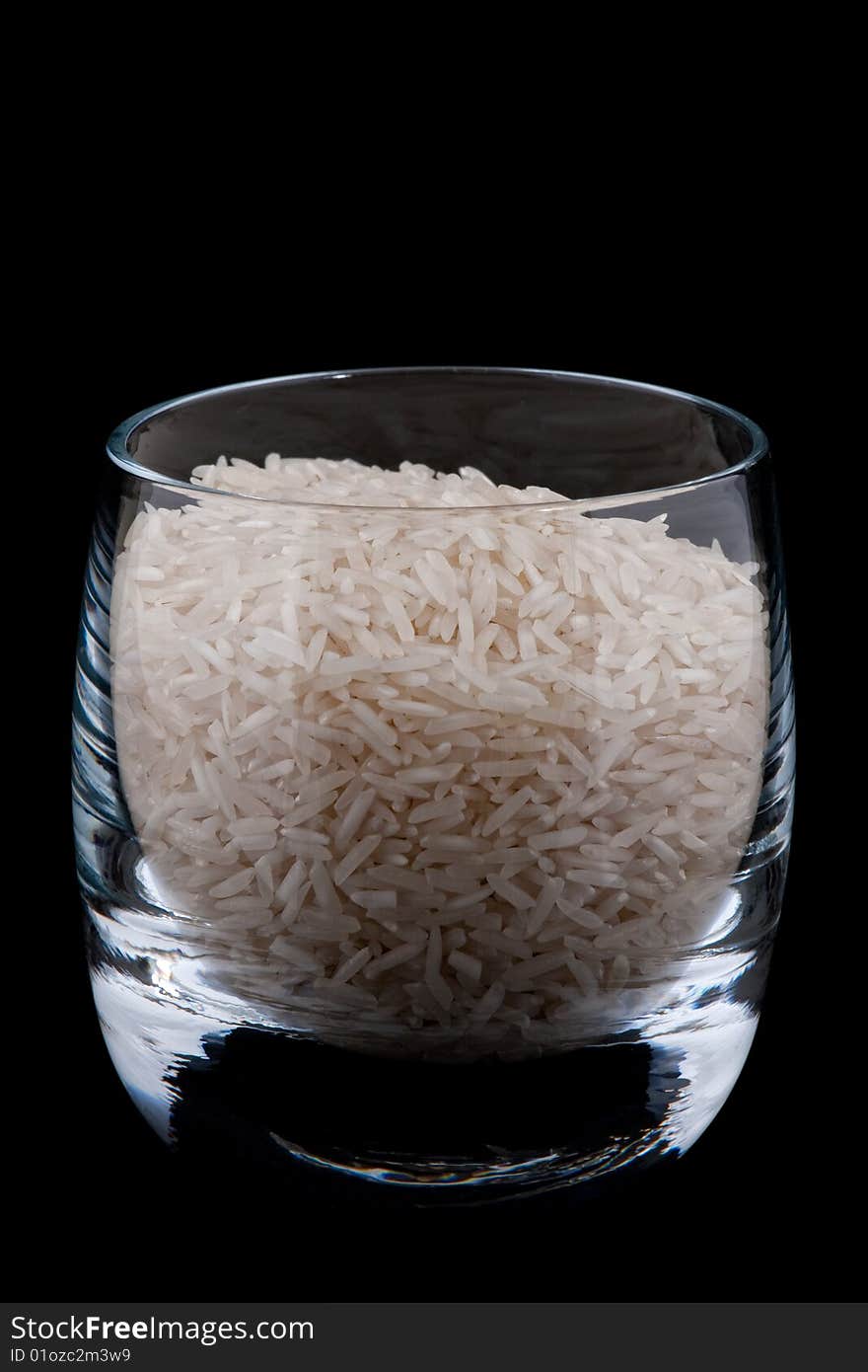 Basmati rice in glass, isolated on black background. Basmati rice in glass, isolated on black background