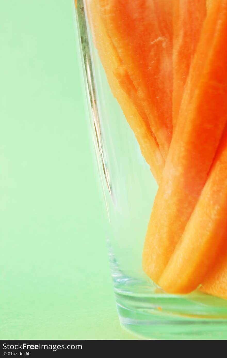 Juicy bars of carrot are in glass. Juicy bars of carrot are in glass