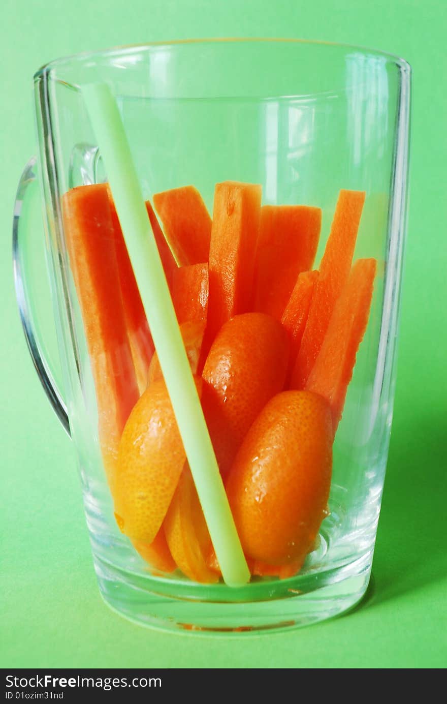 Juicy carrot bars with kumquats in transparent glass. Juicy carrot bars with kumquats in transparent glass