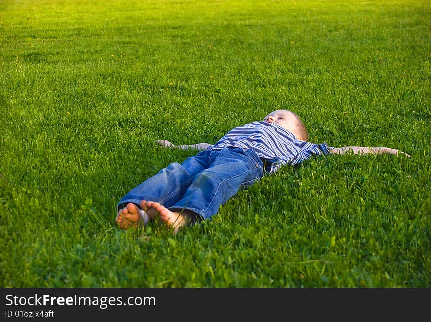 Boy lies on a grass