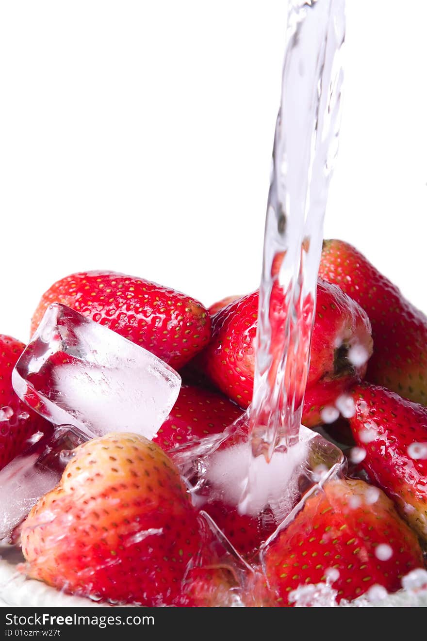 Pouring water on strawberries on a white background. Pouring water on strawberries on a white background