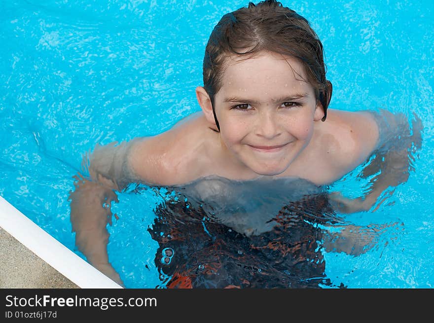 A young boy in pool with goggles on. A young boy in pool with goggles on