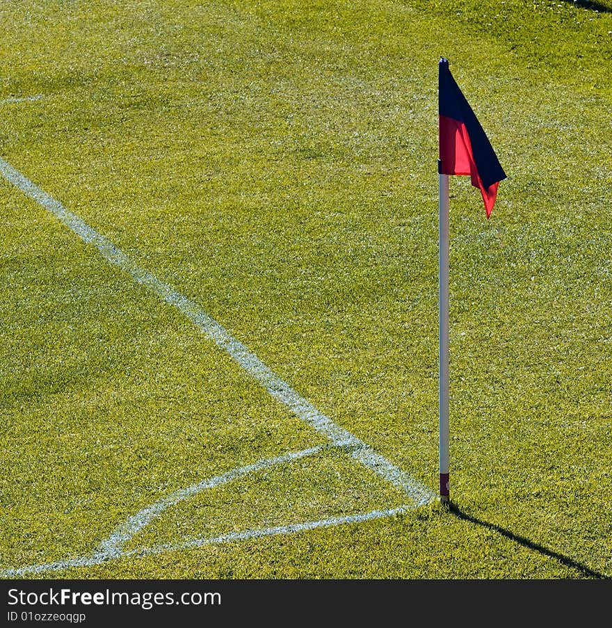 Corner on football pitch with red anb blue flag. Corner on football pitch with red anb blue flag