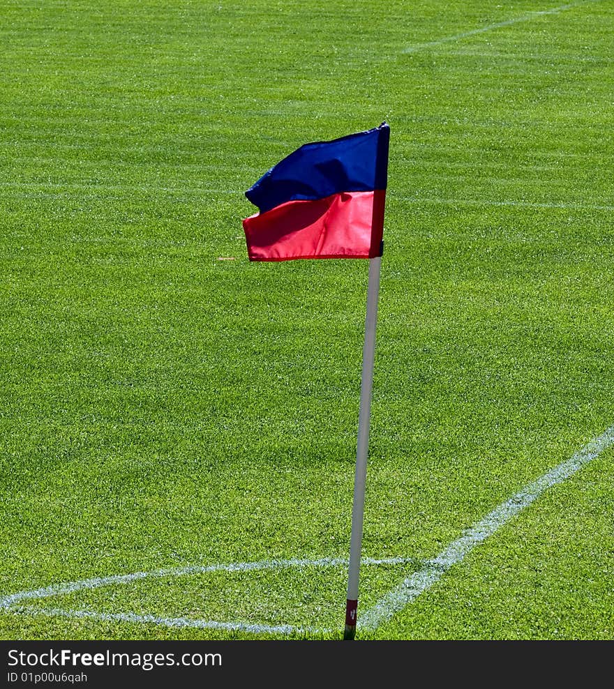 Corner on football pitch with red anb blue flag. Corner on football pitch with red anb blue flag