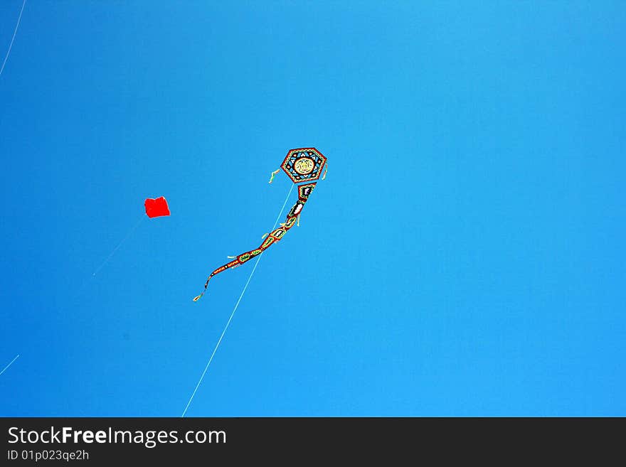 Kite on blue summer sky