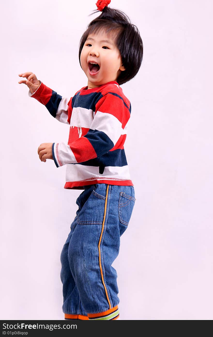 Picture of a little chinese girl with pigtail jumping and laughing happily