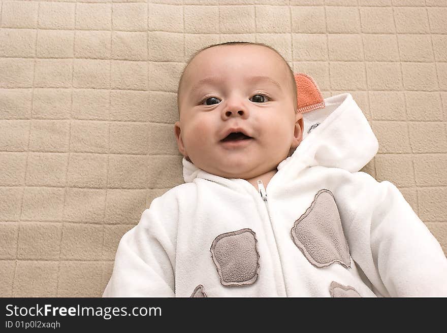 Beautiful baby boy smiling on bed. Beautiful baby boy smiling on bed.