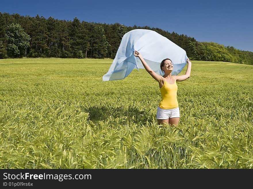 A beautiful woman feels happy on the field. A beautiful woman feels happy on the field.