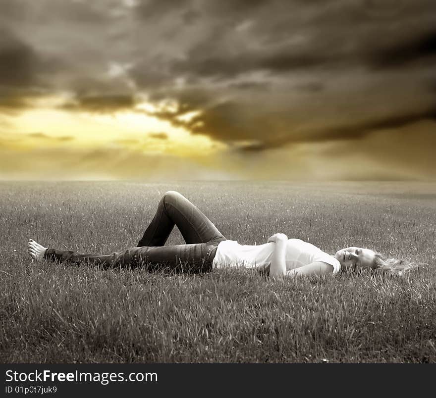 Young woman lying on grass field. Young woman lying on grass field