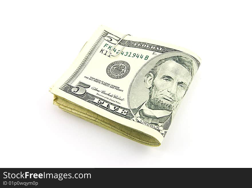 Fold of single dollar bills with paper clip on a white background. Fold of single dollar bills with paper clip on a white background