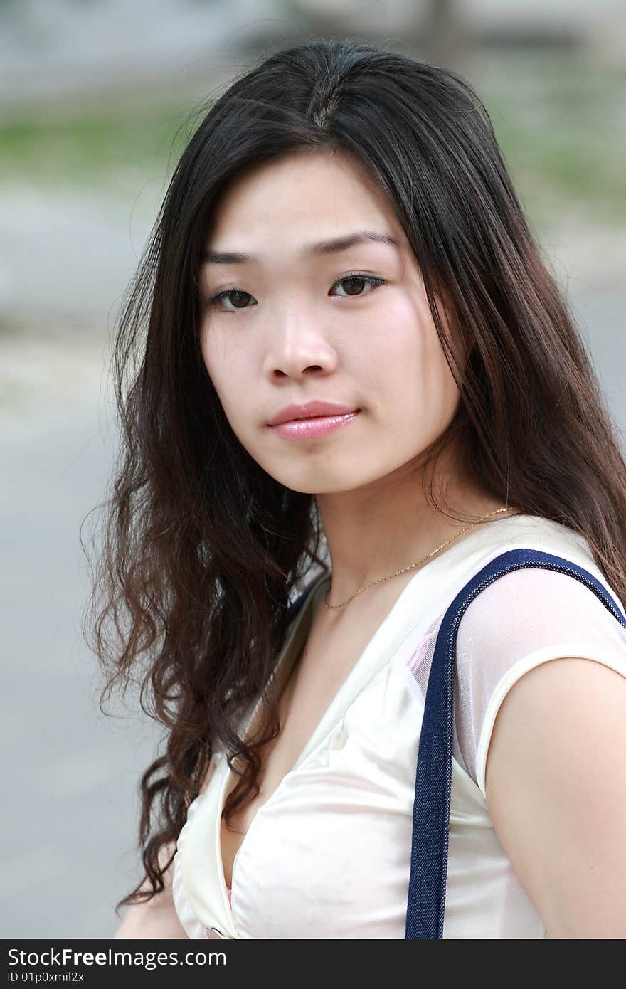 A modern asian girl's portrait outdoors. A modern asian girl's portrait outdoors.