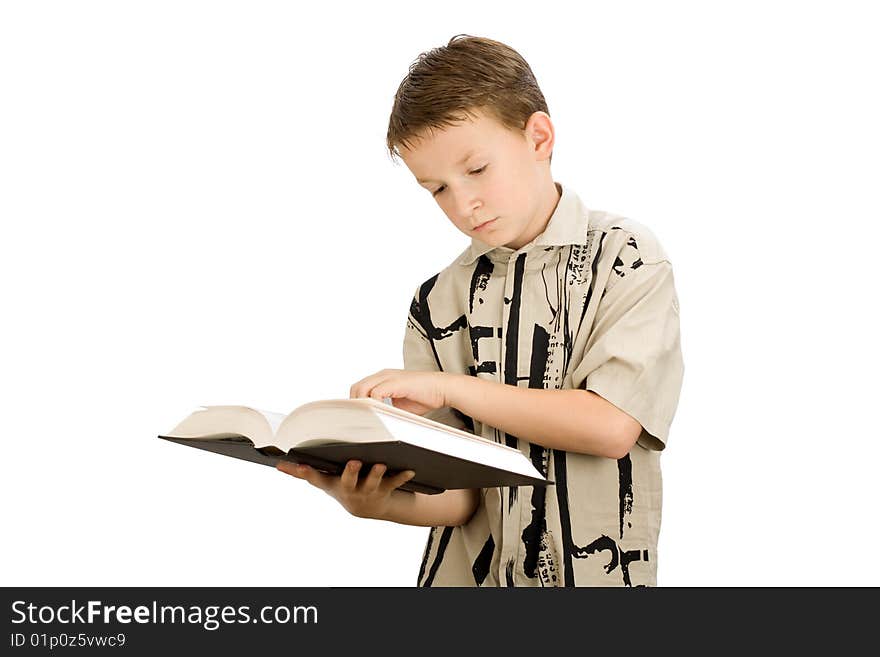 Young school boy studying a book