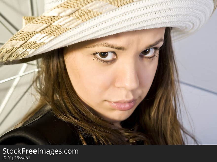 Young woman under umbrella, posing isolated