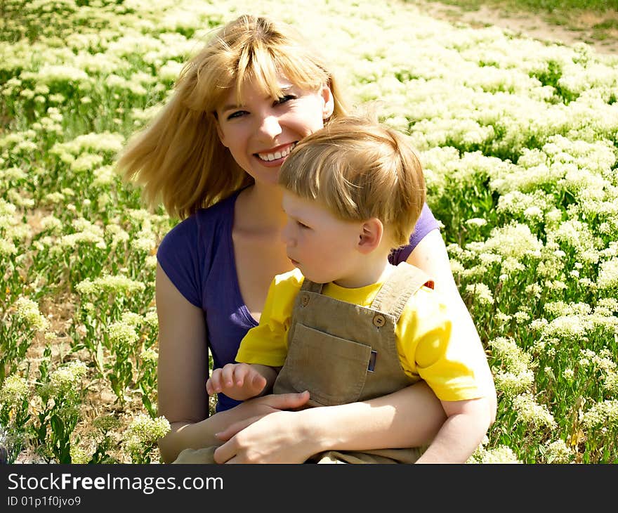 Young mum with the son on a floor from colors. Young mum with the son on a floor from colors