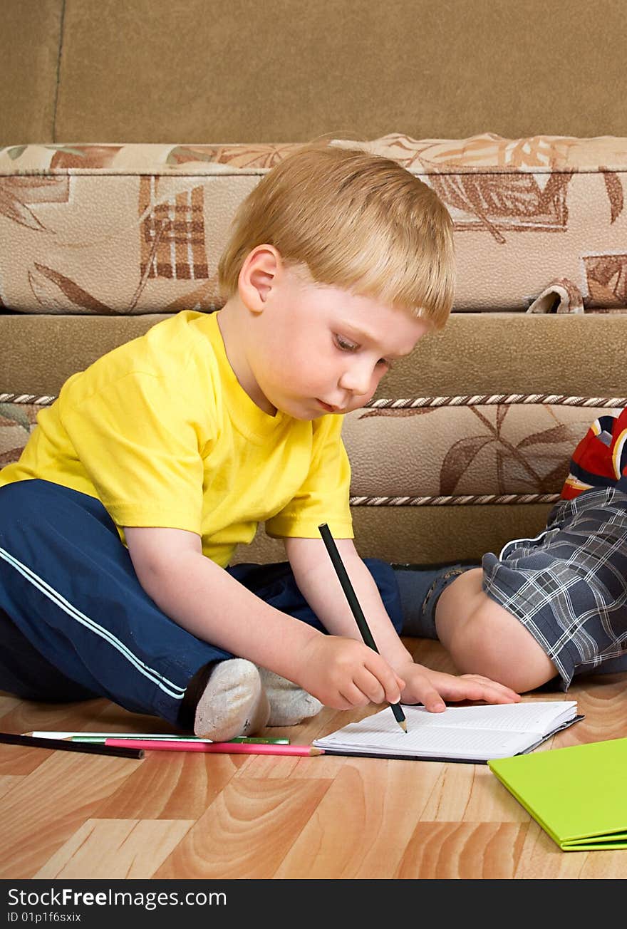 Boy draw with paints sitting on floor. Boy draw with paints sitting on floor