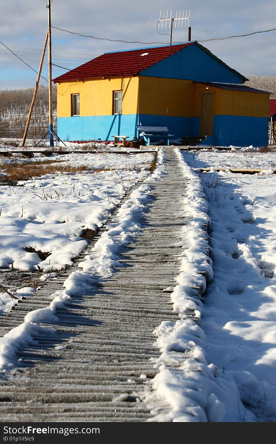 Road to the yellow house in snow. Road to the yellow house in snow