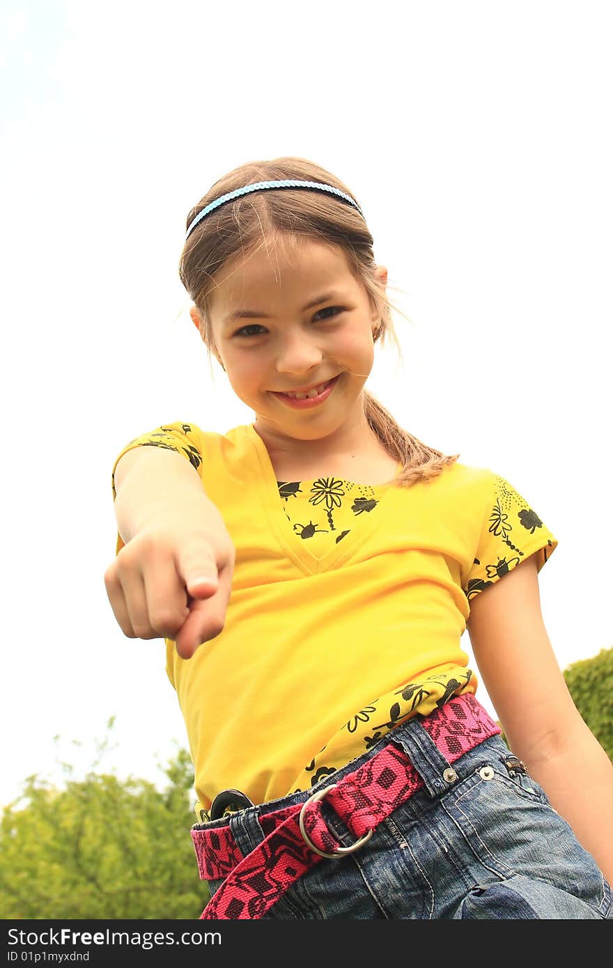 Happy young girl poses in front of the camera. Happy young girl poses in front of the camera