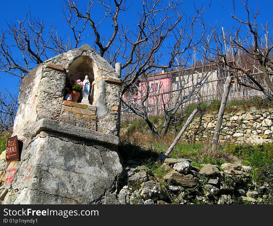 rustic religion architecture, virgin mary chapel in orchard. rustic religion architecture, virgin mary chapel in orchard