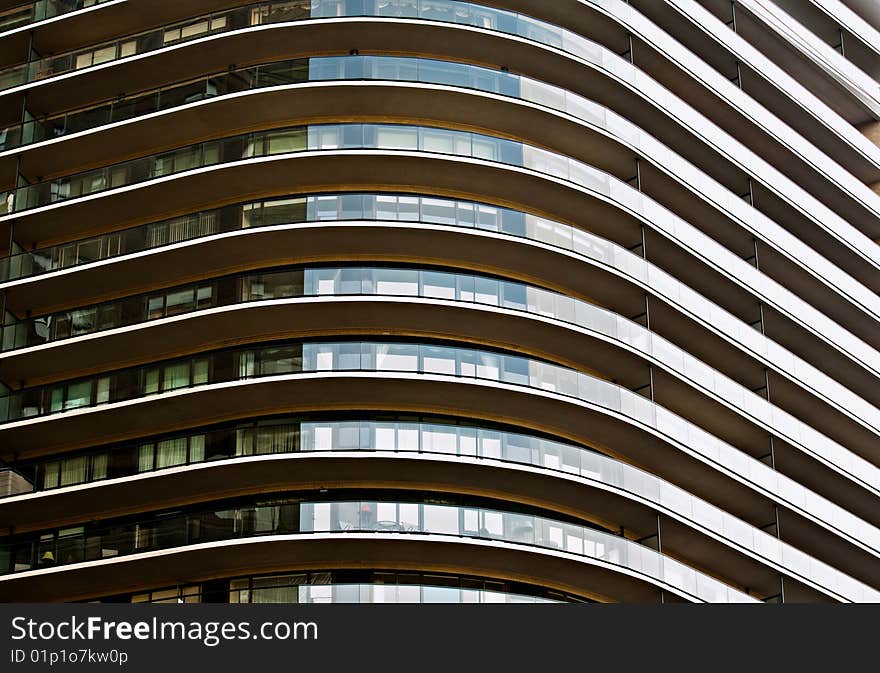 A modern NYC building with wrap around balconies creating a linear and angular abstract. A modern NYC building with wrap around balconies creating a linear and angular abstract