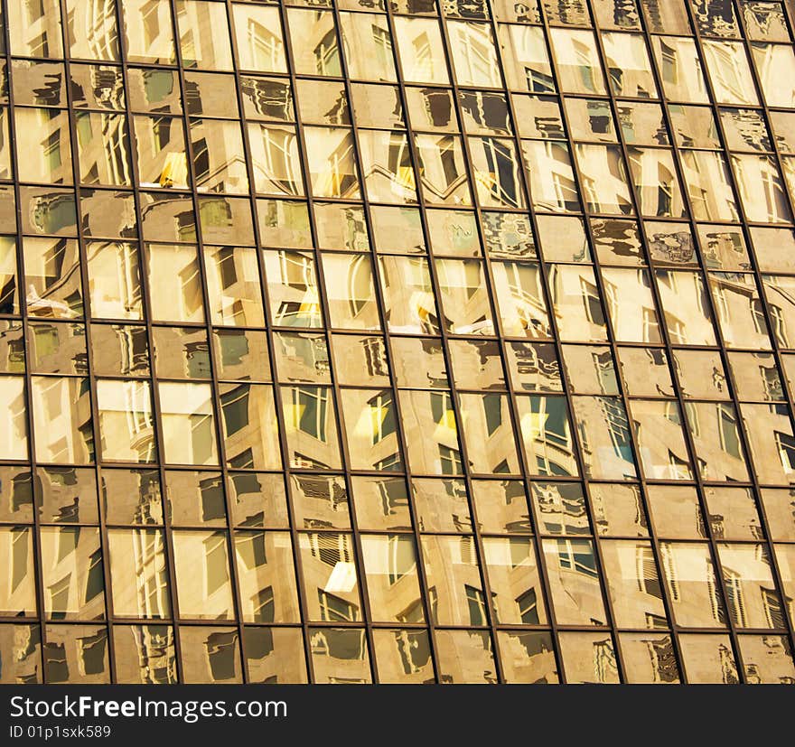 A modern NYC building with windows reflecting other buildings windows. A modern NYC building with windows reflecting other buildings windows.