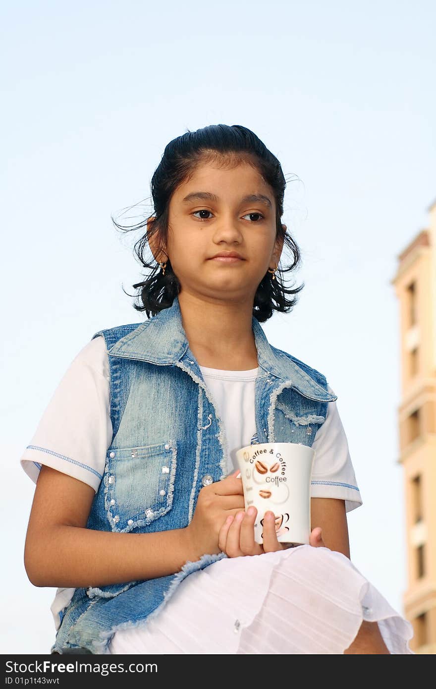 A small Indian girl engrossed in her beautiful tender thoughts. A small Indian girl engrossed in her beautiful tender thoughts.