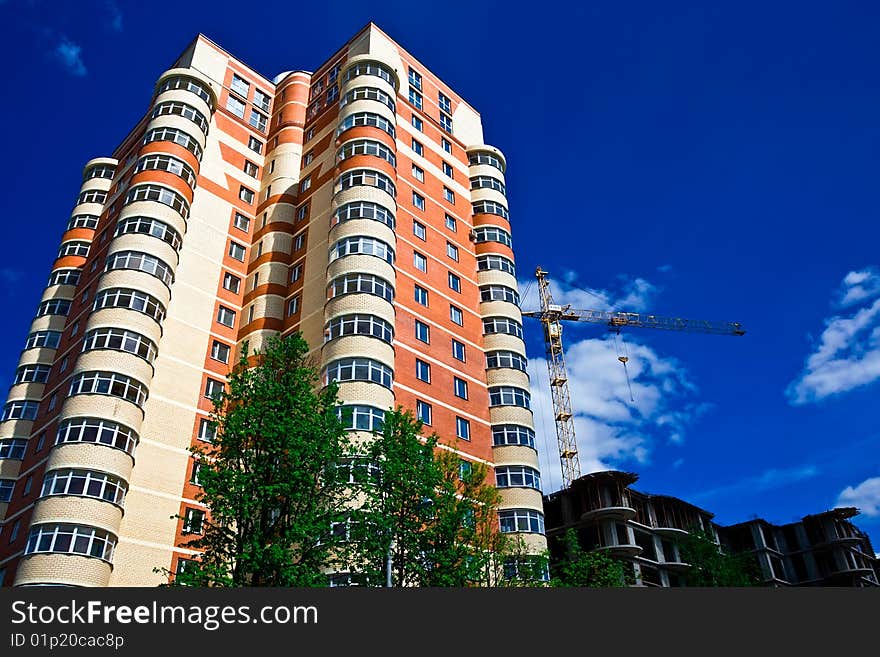 High modern apartment building under blue sky. High modern apartment building under blue sky