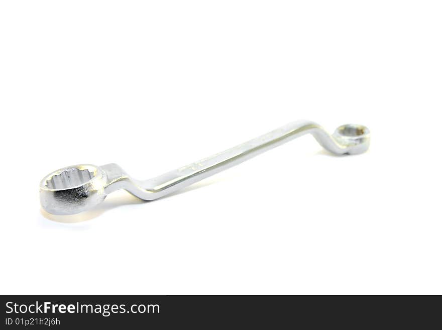 Single shiny chrome spanner on a white background