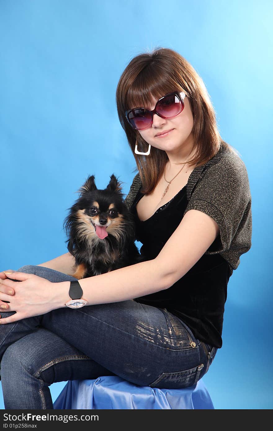 The girl with the doggie on a blue background