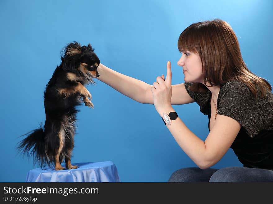 The Girl With The Doggie On A Blue Background