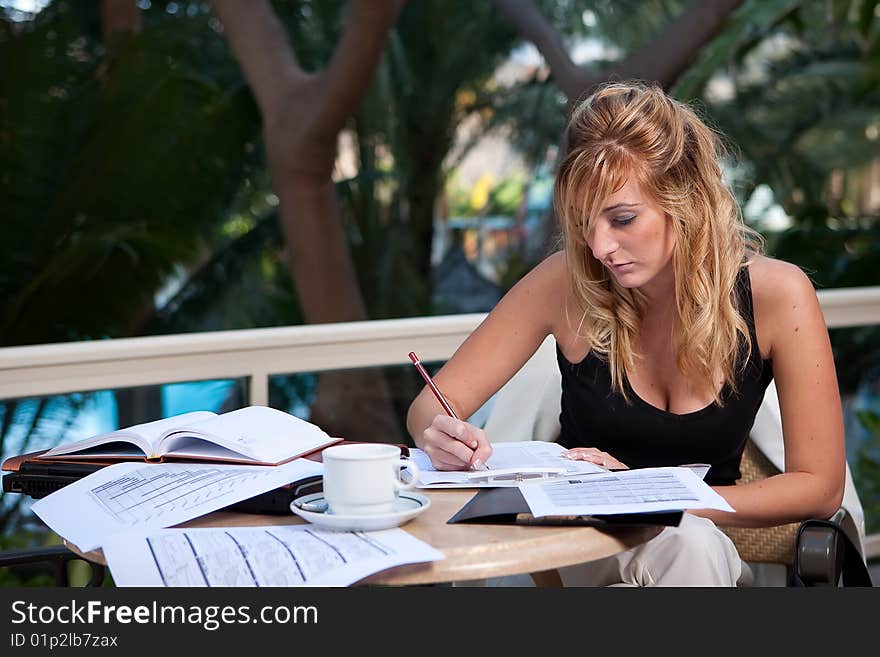 Young attractive businesswoman working in a restaurant terrace