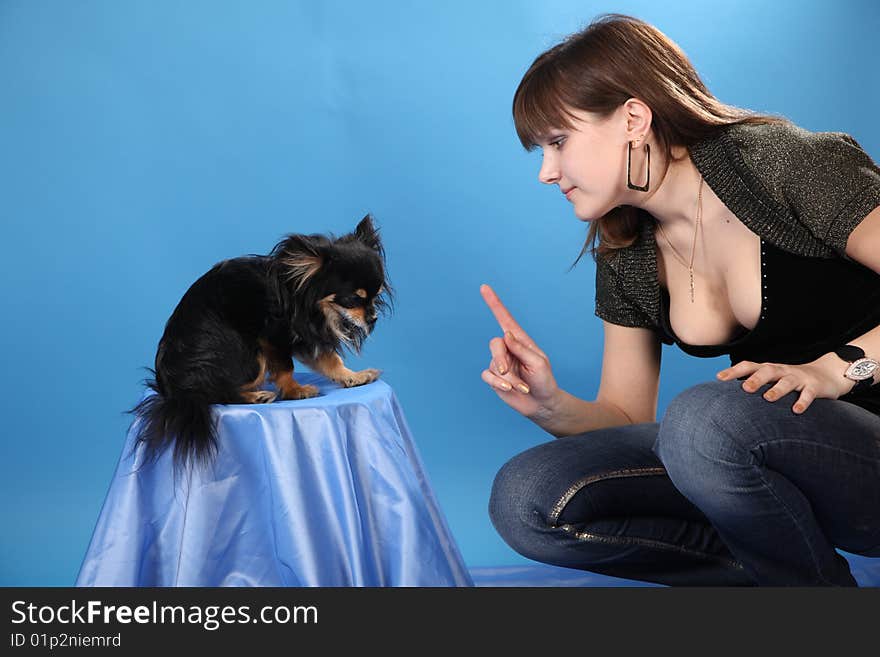 The girl with the doggie on a blue background