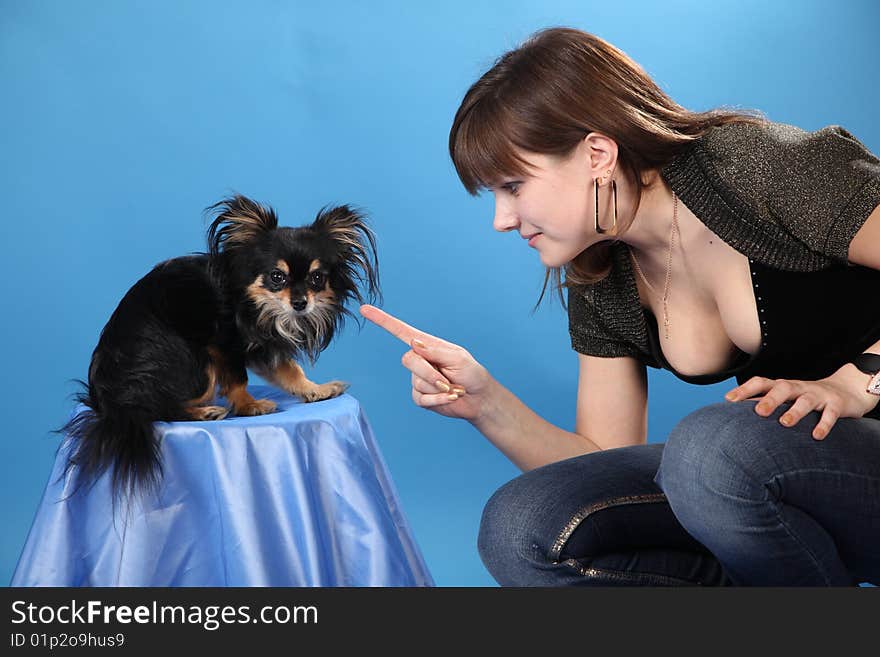 The girl with the doggie on a blue background