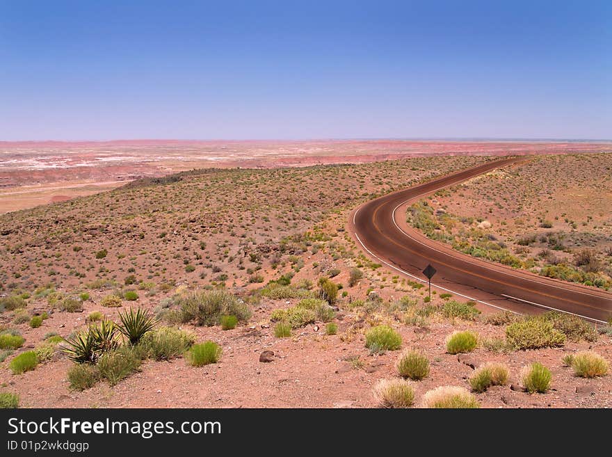 A lone highway runs through the Arizona desert. A lone highway runs through the Arizona desert.