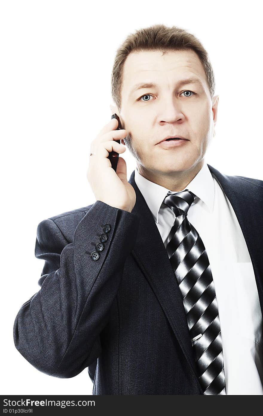 Portrait of a middle aged businessman talking on his mobile phone. Shot in a studio. Portrait of a middle aged businessman talking on his mobile phone. Shot in a studio.