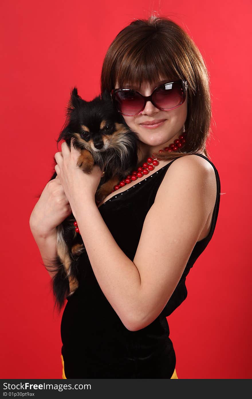 The young girl on a red background. The young girl on a red background