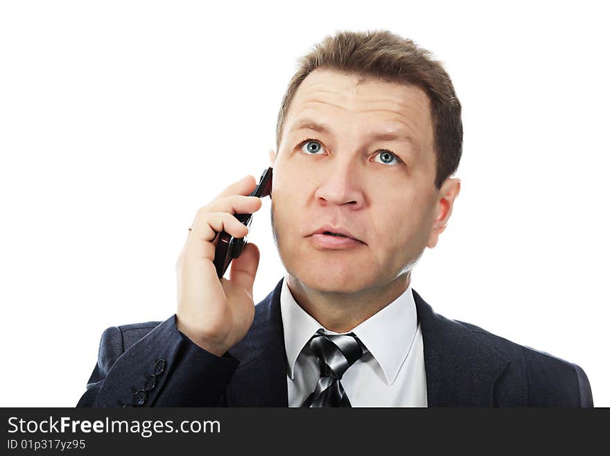 Portrait of a middle aged businessman talking on his mobile phone. Shot in a studio. Portrait of a middle aged businessman talking on his mobile phone. Shot in a studio.