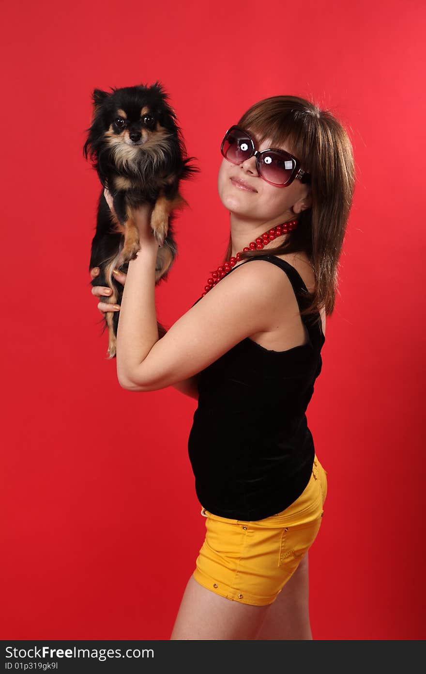 The young girl on a red background. The young girl on a red background