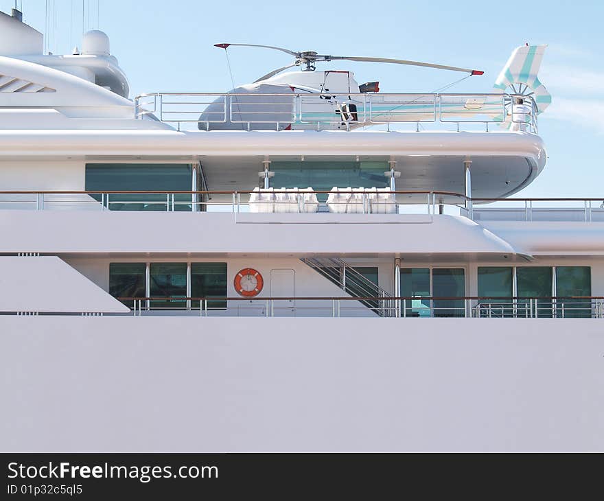 Helicopter sitting on the deck of a private yacht. Helicopter sitting on the deck of a private yacht