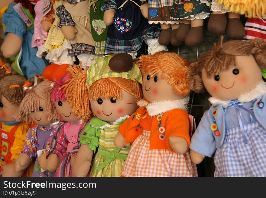 The picture shows colourful, smiling dolls. The picture shows colourful, smiling dolls.
