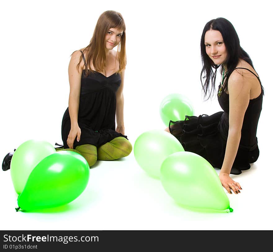 Two young girls with green ballons