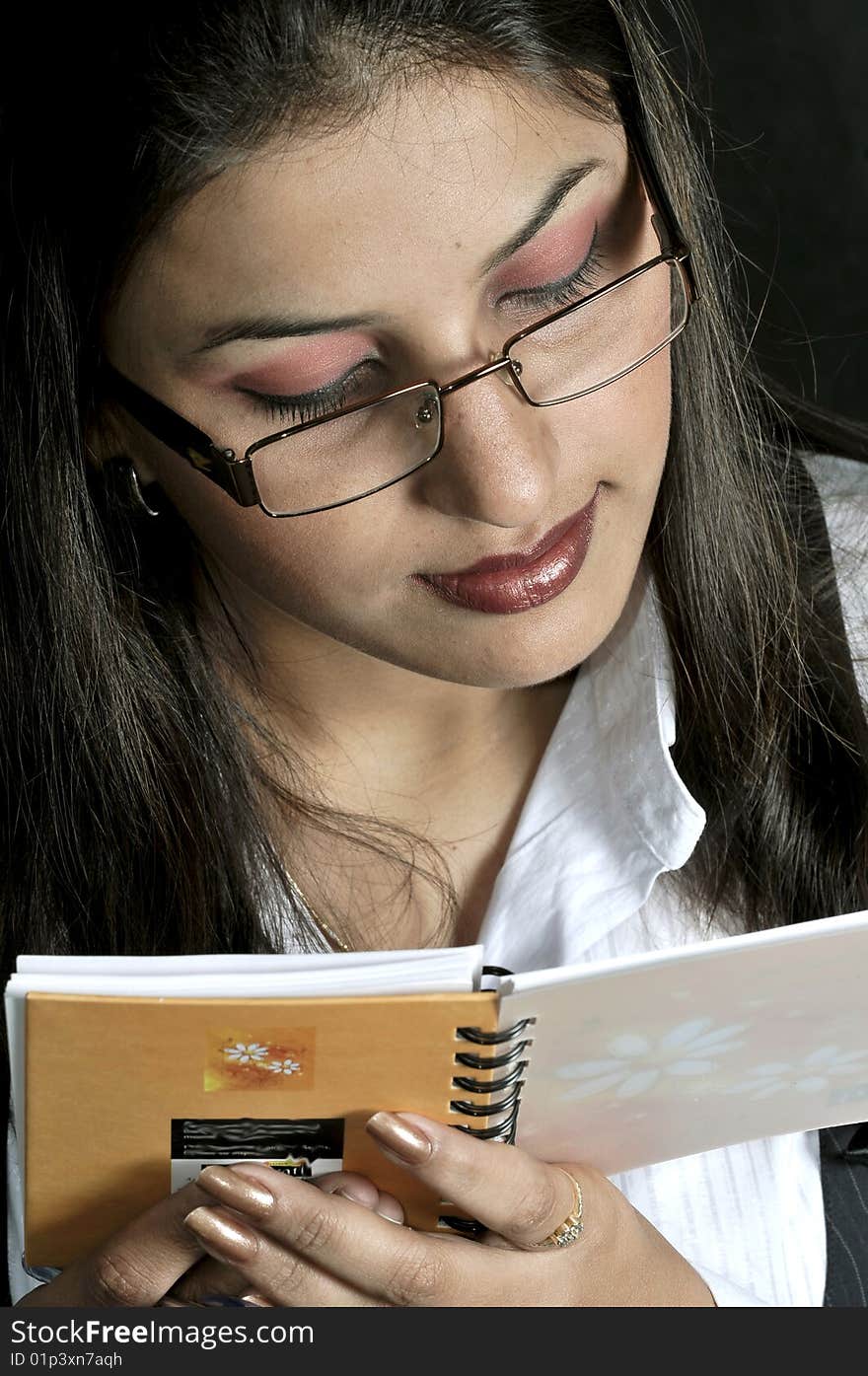 Girl reading the notebook in studio.