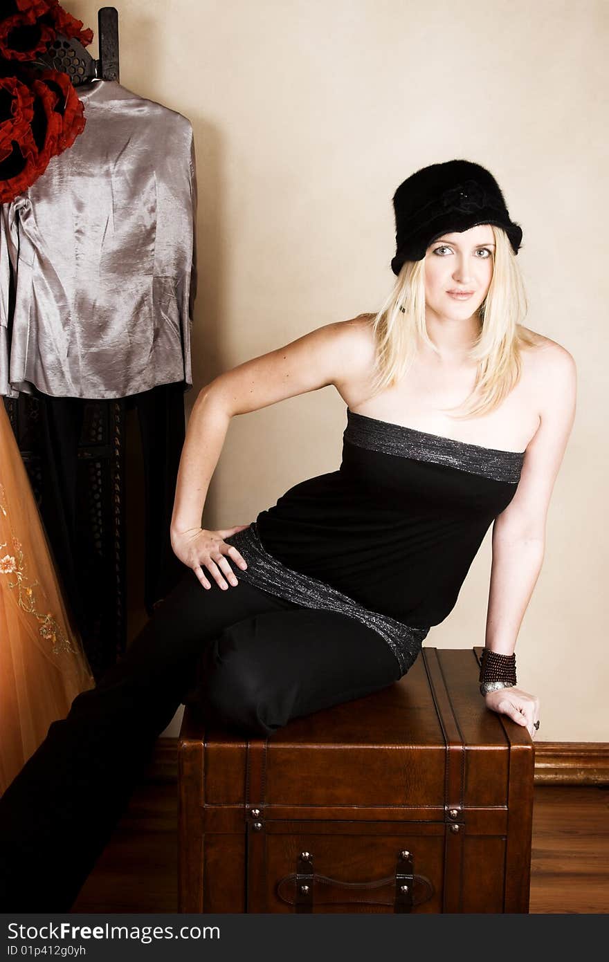 Beautiful young blond model wearing a black hat. Beautiful young blond model wearing a black hat