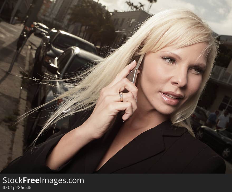 Blond businesswoman on a cell phone. Blond businesswoman on a cell phone