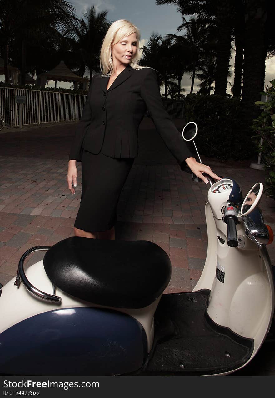 Businesswoman and a motor scooter