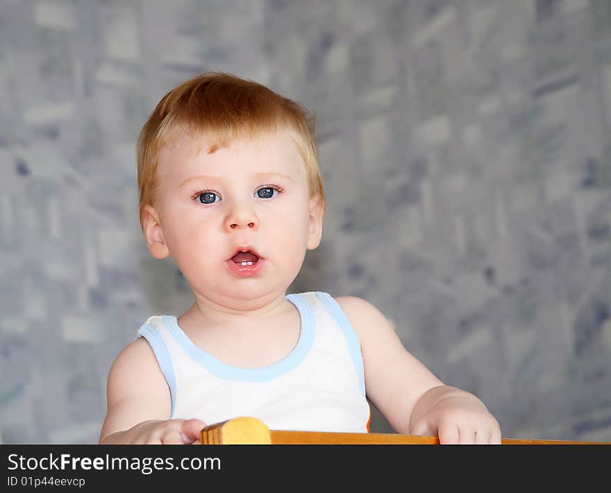 The small fair-haired boy looks directly in the chamber. The small fair-haired boy looks directly in the chamber